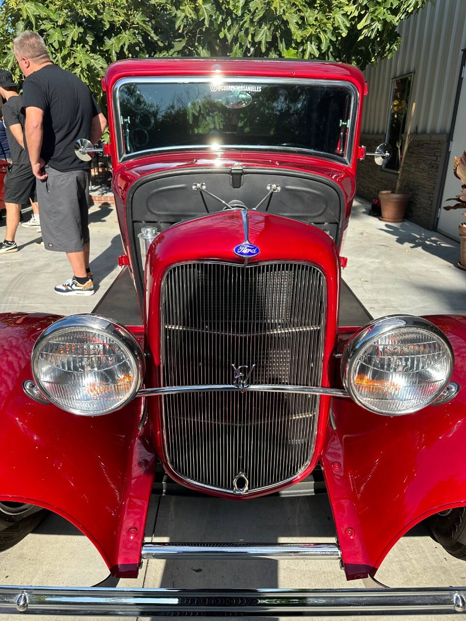 A red 1932 Ford Deuce Coupe viewed from the front, electrified by the team at Current LA.